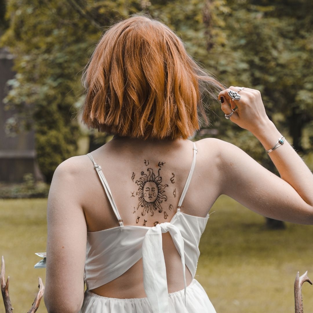 Woman with zodiac tattoo on her back
