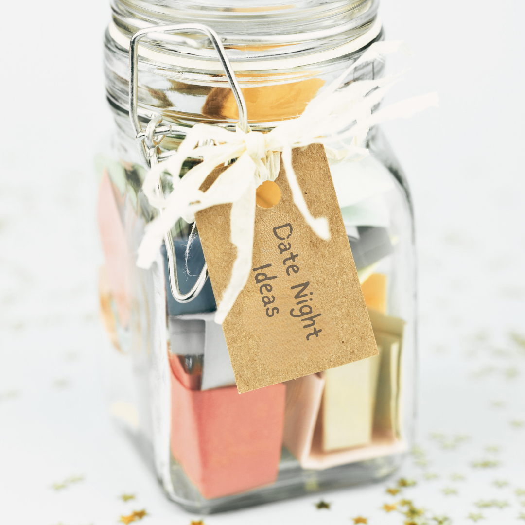 Clear jar with folded up piece of paper with date night ideas on them