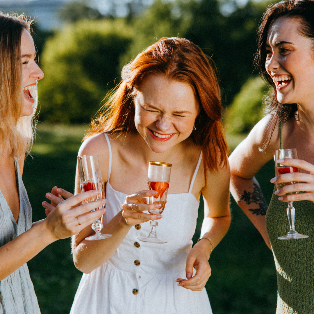 Three Girls Laughing and Drinking Wine