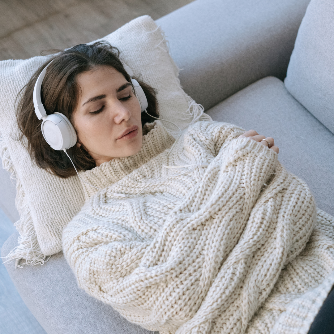 Woman Sleeping in a Sofa with a Headset